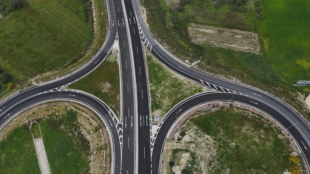 Aerial view of a highway interchange with white road markings